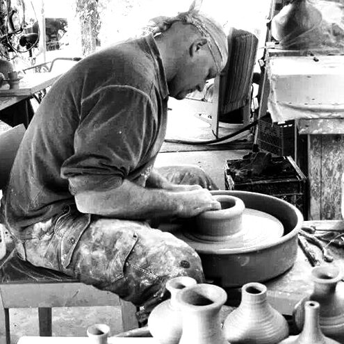 Doug Jackson sitting at his pottery wheel
